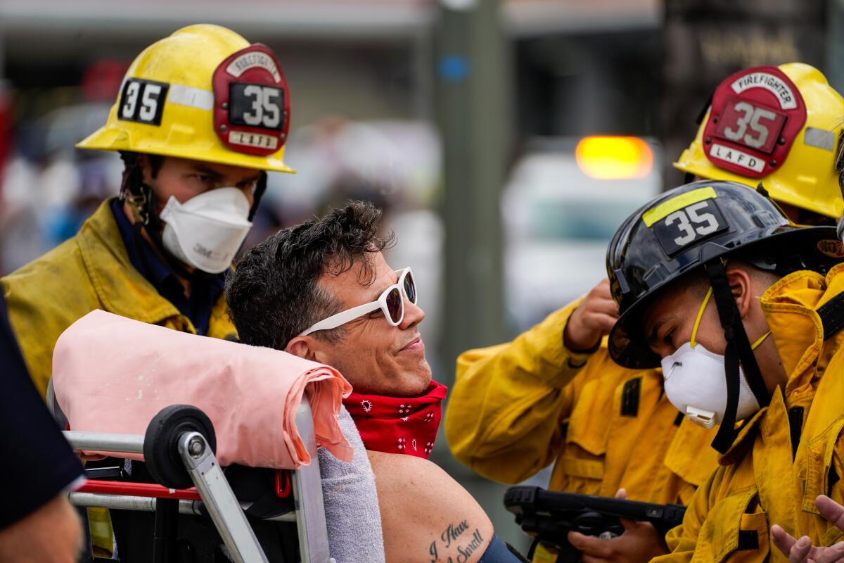 Steve-O is checked out by firefighters after being brought down from a Hollywood billboard on Thursday.