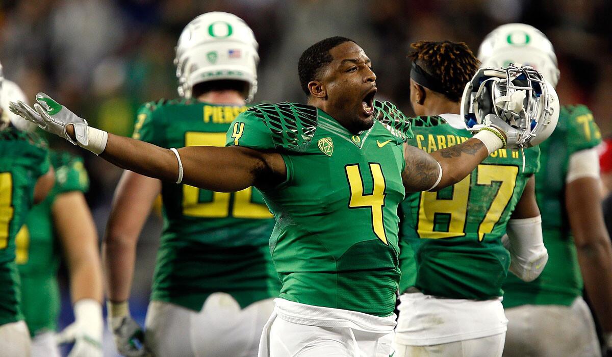Oregon defensive back Erick Dargan, celebrating toward the end of the Ducks' Pac-12 title game win, admits the pressure will be on his unit to perform in the Rose Bowl game.