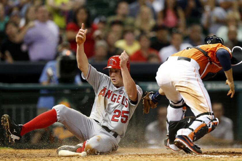 Angels outfielder Peter Bourjos scores in the eighth inning Friday night in Houston, beating the throw to Astros catcher Jason Castro. On Saturday, Bourjos was injured yet again.