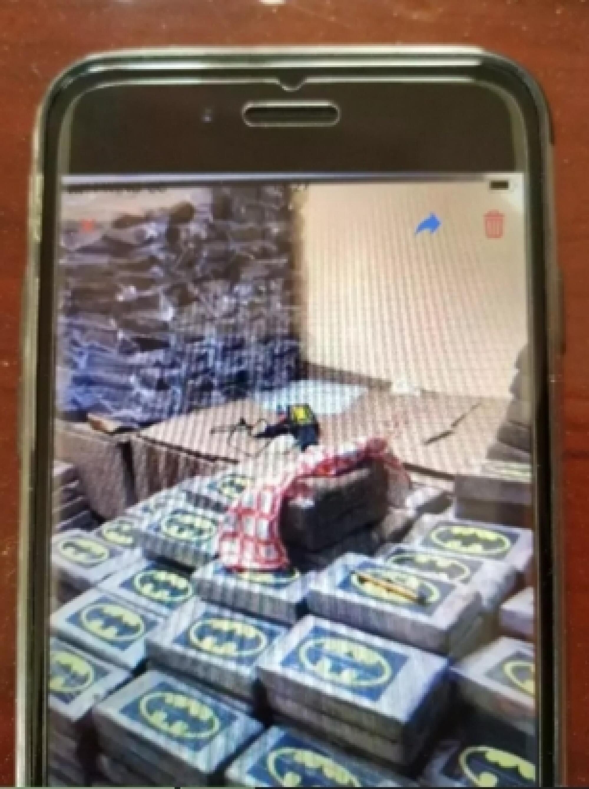 A photo of bricks of cocaine stamped with the Batman logo was sent from one Anom user to another in January 2020.