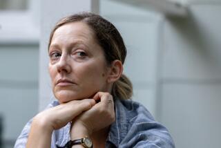 A woman stares warily.