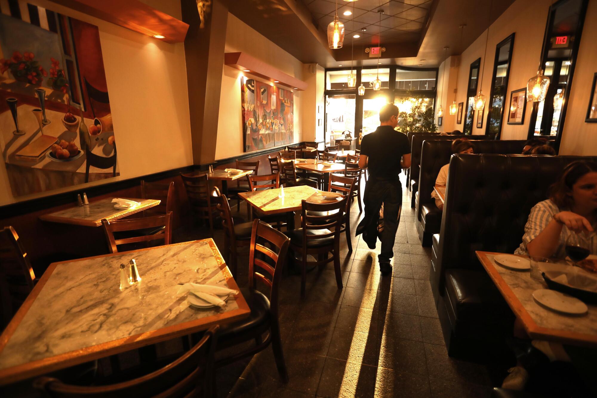 Server Battur Erdenebat tends to customers at Louise's Trattoria.