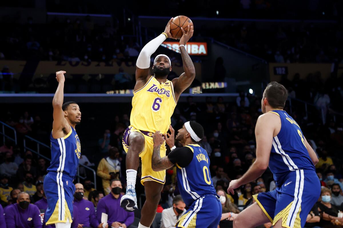 Lakers forward LeBron James shoots over Golden State Warriors guard Gary Payton II.
