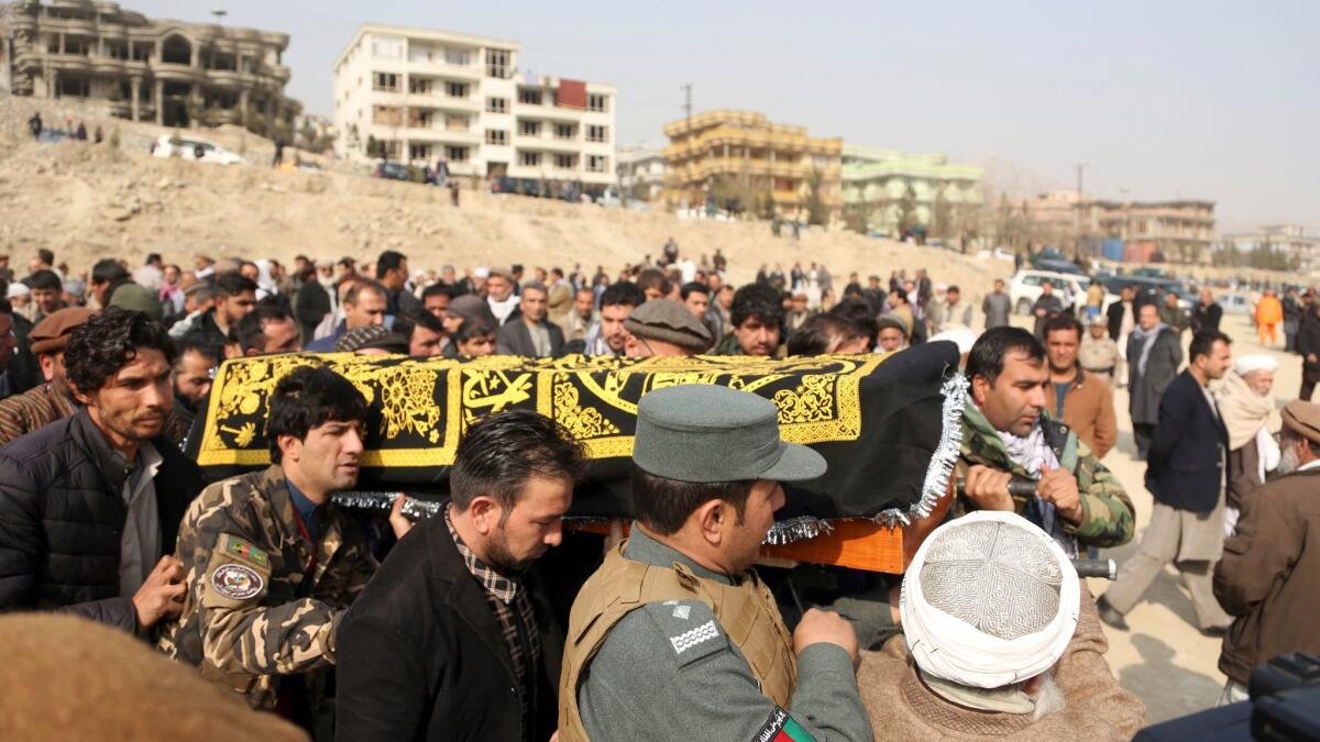 Men carry the coffin of a relative who died in Saturday's suicide attack in Kabul.
