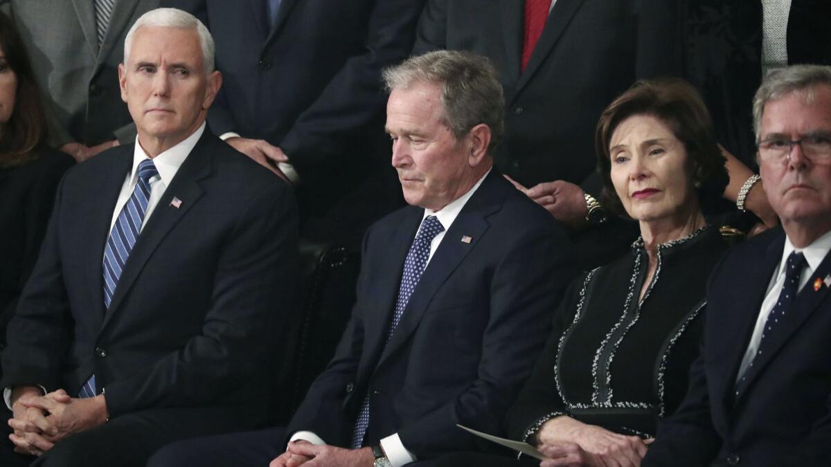 Former President George W. Bush, second from left, former First Lady Laura Bush, former Florida Gov. Jeb Bush, right, and Vice President Mike Pence, left, attend Monday's service for former President George H.W. Bush