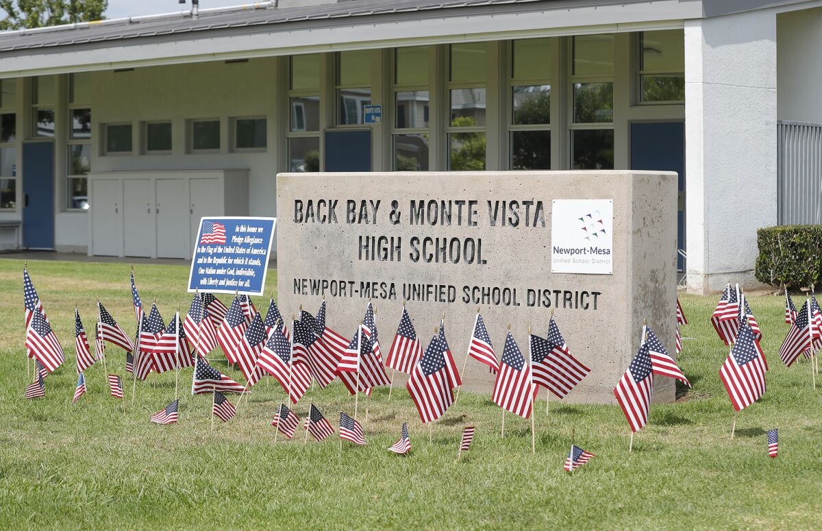 Small American flags are placed around the Back Bay and Monte Vista High School marquee sign.