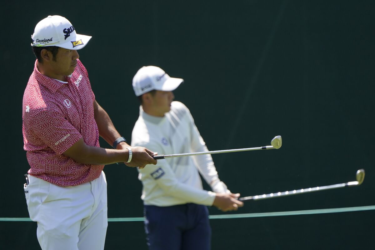 Hideki Matsuyama, of Japan, and Amateur Keita Nakajima, of Japan, hit shots on the 15th hole during a practice round for the Masters golf tournament on Monday, April 4, 2022, in Augusta, Ga. (AP Photo/Jae C. Hong)