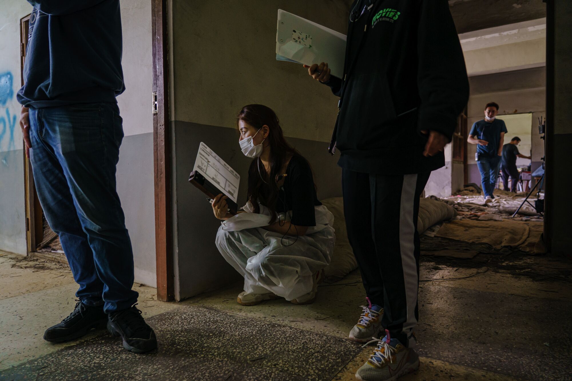 Slate operator Jieun Nam watches as the 'Tearless' film crew prepares to shoot.
