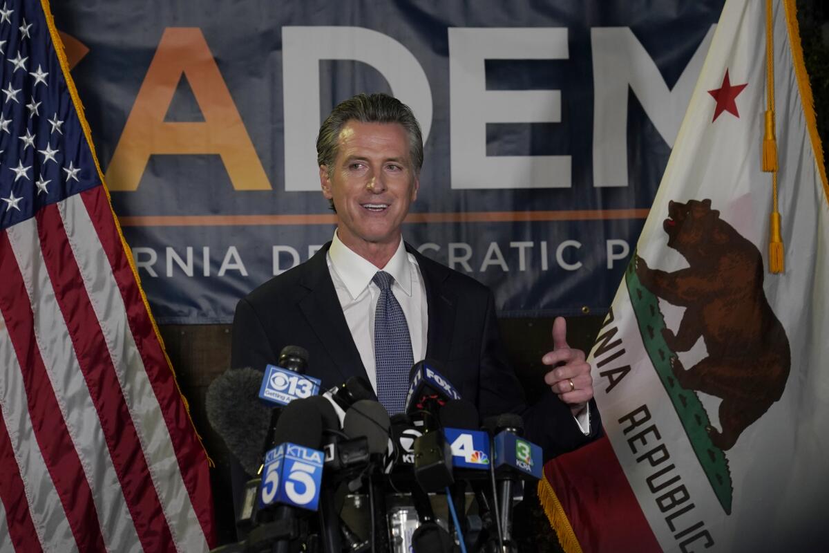 California Gov. Gavin Newsom addresses reporters, after beating back the recall attempt