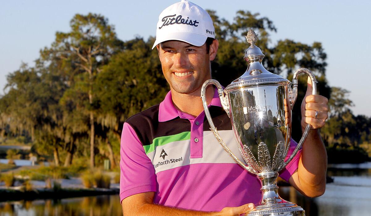 Robert Streb poses with the winner's trophy after claiming victory at the McGladrey Classic on Sunday.