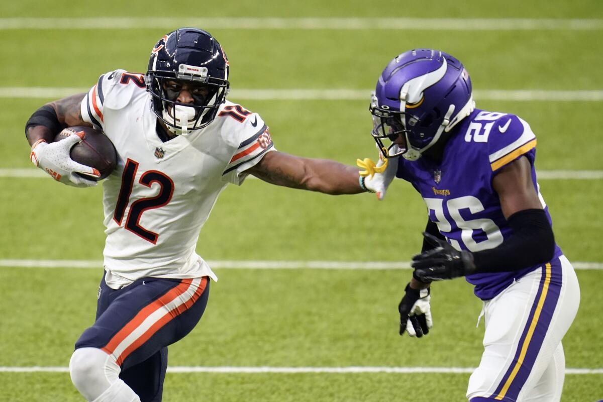 FILE - In this Dec. 20, 2020, file photo, Chicago Bears wide receiver Allen Robinson II (12) runs from Minnesota Vikings cornerback Chris Jones (26) after catching a pass during the second half of an NFL football game in Minneapolis. Robinson insisted a contract negotiation that left him playing this season on the franchise tag rather than a multiyear deal did not give him a chip on his shoulder or an extra desire to show his worth. (AP Photo/Jim Mone, File)