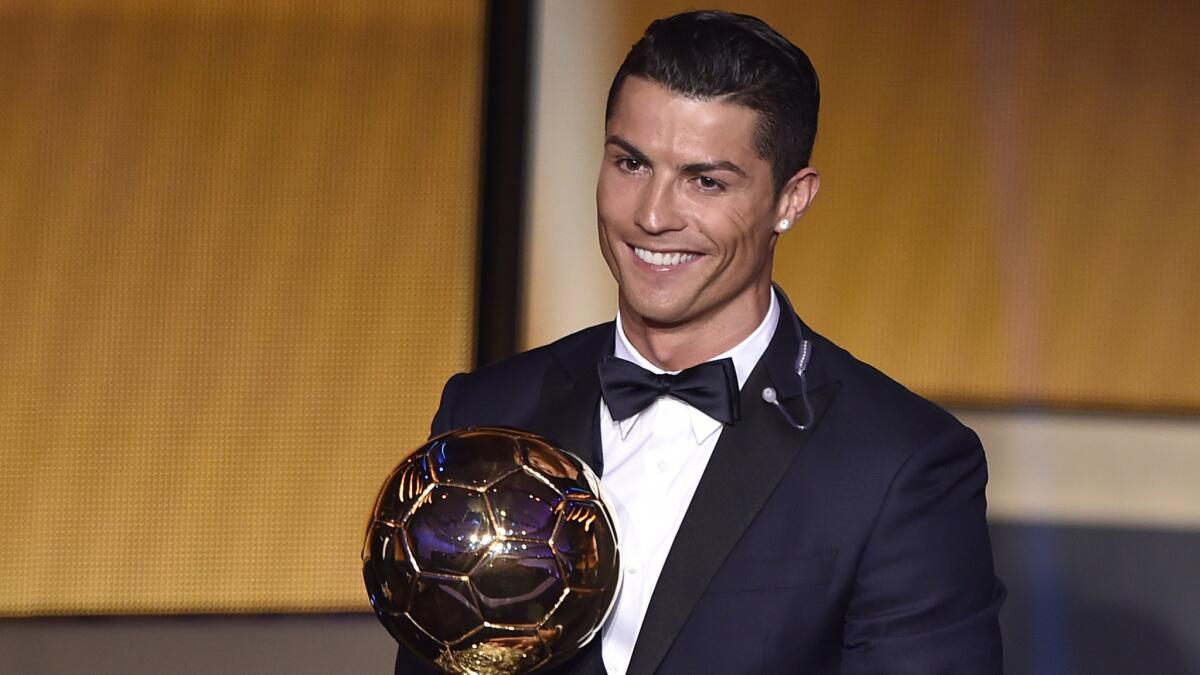 Real Madrid and Portugal forward Cristiano Ronaldo smiles after receiving the FIFA Ballon d'Or award for male player of the year.
