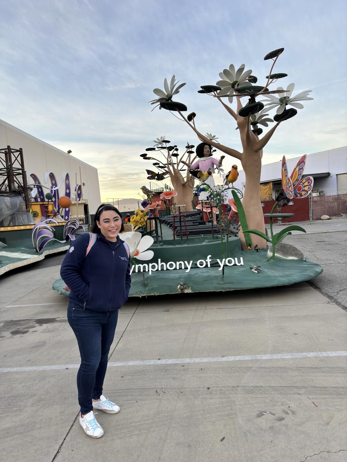 Dr. Alison Taur of Newport Beach poses in front of an early version of Kaiser Permanente's Rose Parade float.