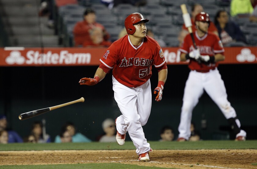 Angels' Ji-Man Choi looks up as he hits a solo home run during the eighth inning of an exhibition game against the Dodgers.
