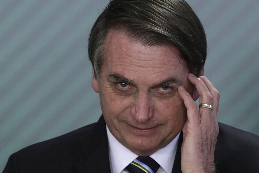 FILE - In this April 9, 2019 file photo, Brazil's President Jair Bolsonaro speaks during a swearing-in ceremony at the Planalto Presidential Palace, in Brasilia, Brazil. Bolsonaro’s latest education minister offered his resignation Tuesday, June 30, 2020, just days after his appointment, creating a new headache for the embattled leader as he struggles to start a new chapter at the ministry and shore up flagging support. (AP Photo/Eraldo Peres, File)