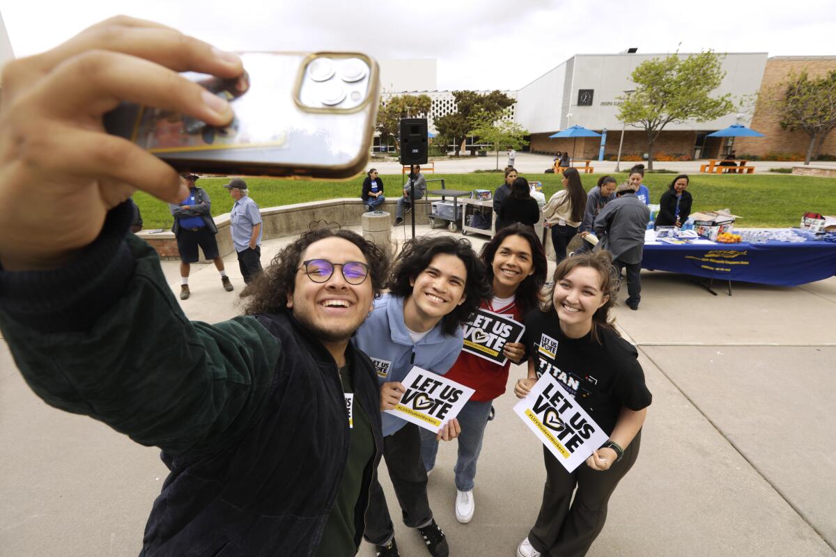 Four students talk a selfie at Cal State University Fullerton