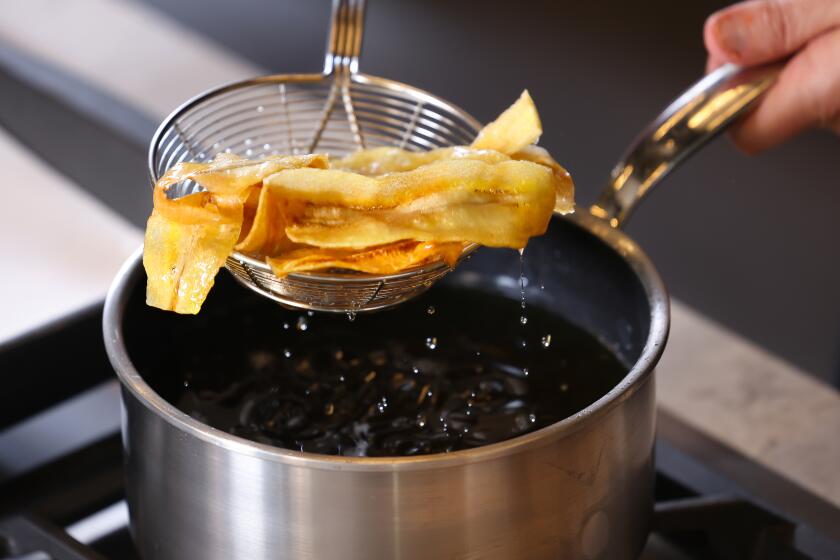 EL SEGUNDO-CA-MAY 30, 2024: Chef Jordan Kahn fries the burro bananas in oil at the Los Angeles Times on May 30, 2024. (Christina House / Los Angeles Times)