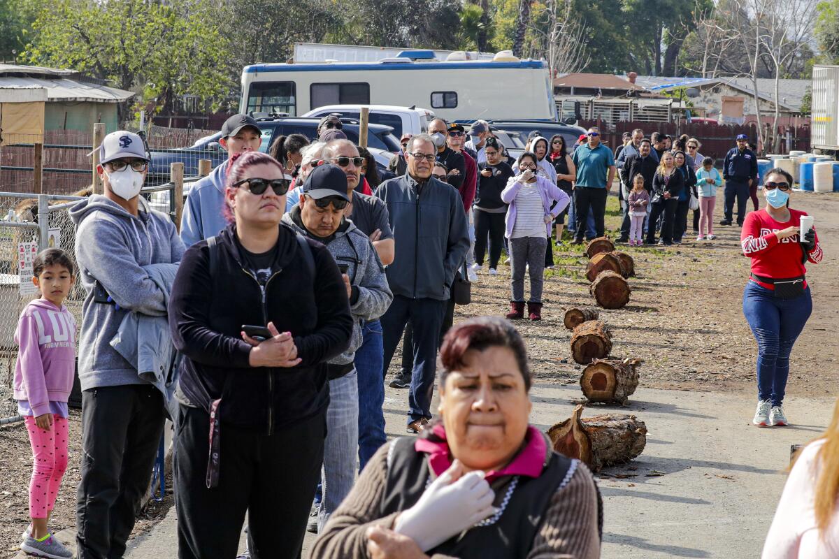 People stand in line to buy eggs at Maust's California Poultry in Chino.