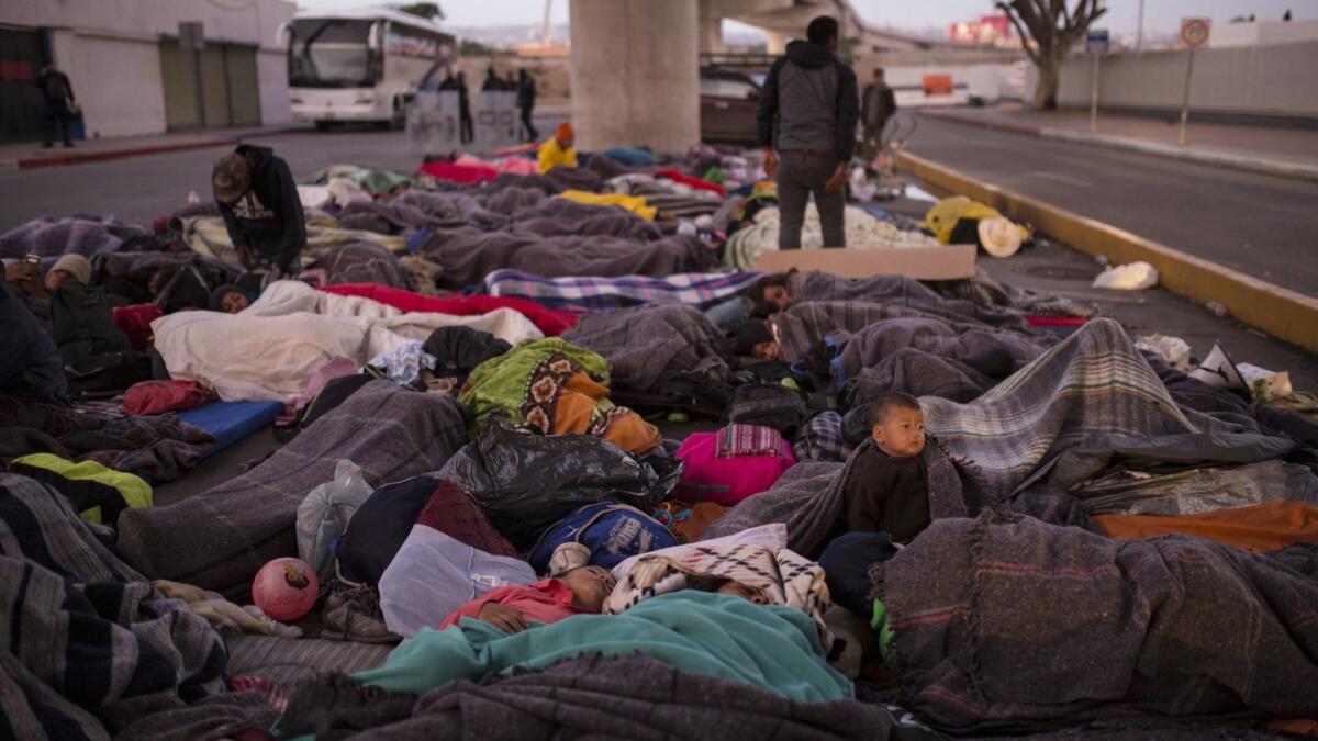 Migrants sleep under a bridge at the Chaparral border crossing in Tijuana, where the mayor has declared a humanitarian crisis.
