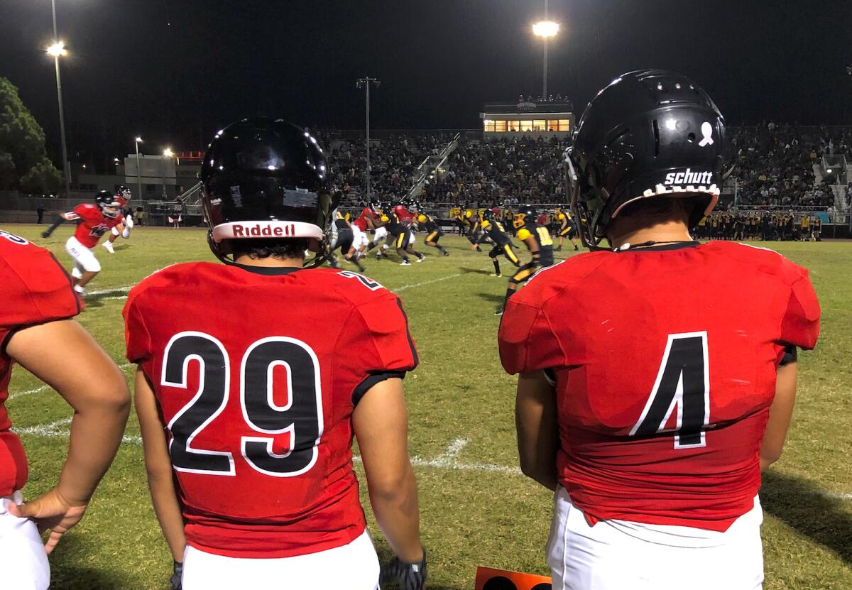 Banning HS football players watch from side line during the Banning-San Pedro prep football game in San Pedro.