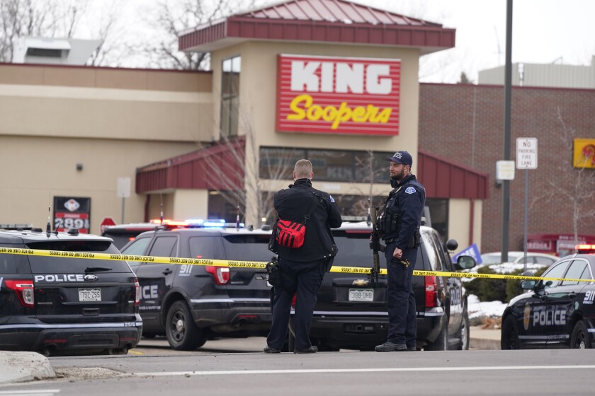 FILE - In this March 22, 2021, file photo, police work on the scene outside of a King Soopers grocery store where a shooting took place in Boulder, Colo. A man charged with killing 10 people at the supermarket surrendered after being shot by a police officer who waited for him to come into view down a store aisle, according new information about the shooting released Thursday, May 6, 2021. The details were contained in a district attorney's report that found Boulder officer Richard Steidell was justified in shooting Ahmad Alissa and said his shots stopped the attack. (AP Photo/David Zalubowski, File)