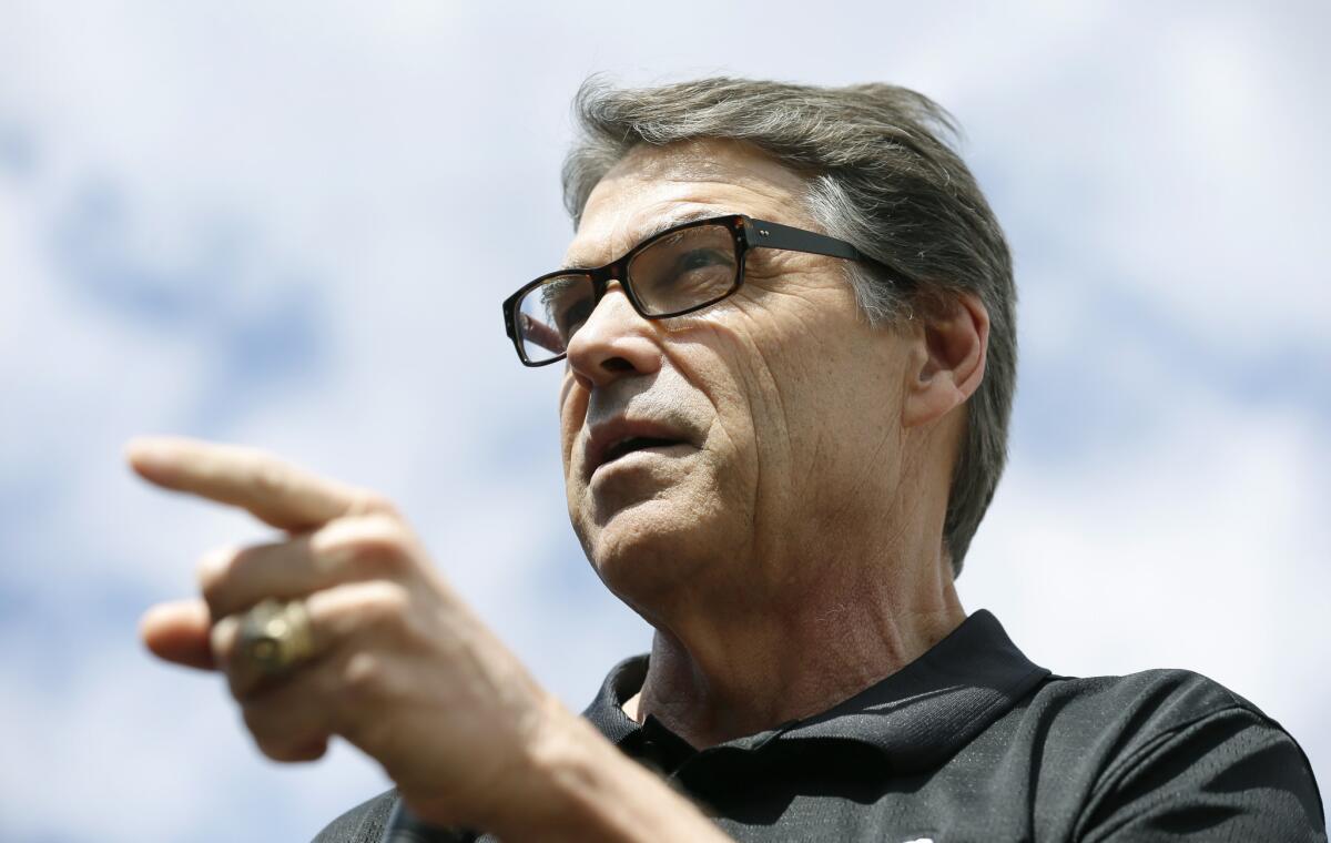 Texas Gov. Rick Perry, shown in Iowa last week, met Wednesday with troops who will deploy to the U.S.-Mexico border.