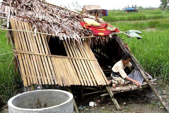 A woman survives in this makeshift shelter in Tontay, Myanmar, more than a month after cyclone Nargis hit the country.