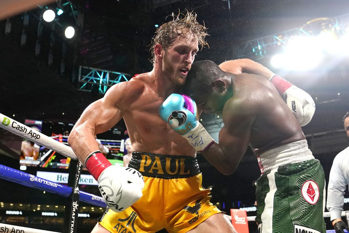 Logan Paul and Floyd Mayweather Jr. fight during an exhibition boxing match at Hard Rock Stadium.