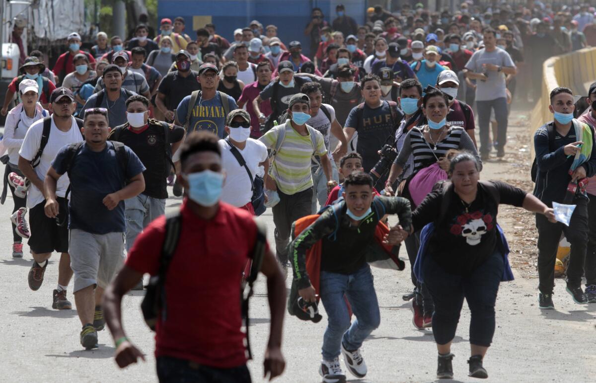 Migrants attempt to cross en masse into Guatemala at Corinto, Honduras, on Oct. 1, 2020.
