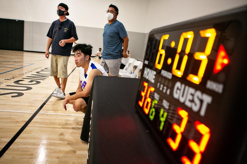 LOS ANGELES, CA - JUNE 27: A player in the Yonsei basketball league waits to go in the game at the Terasaki Budokan Center in Little Tokyo on Sunday, June 27, 2021 in Los Angeles, CA. (Jason Armond / Los Angeles Times)