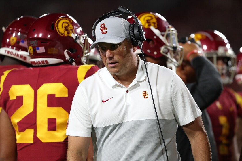 USC coach Clay Helton walks on the sideline.