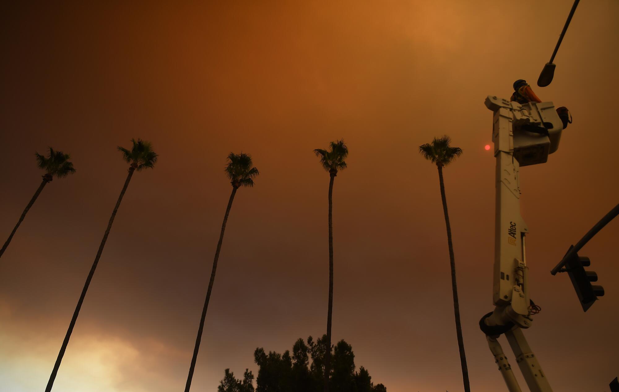 A street camera is installed on a light post along North Azuza Avenue as smoke from the Bobcat fire fills the sky.