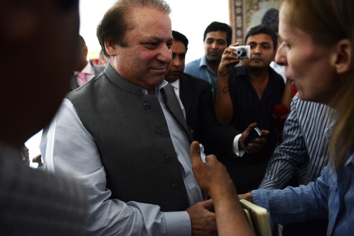 Nawaz Sharif greets journalists at his farmhouse on the outskirts of Lahore, Pakistan.