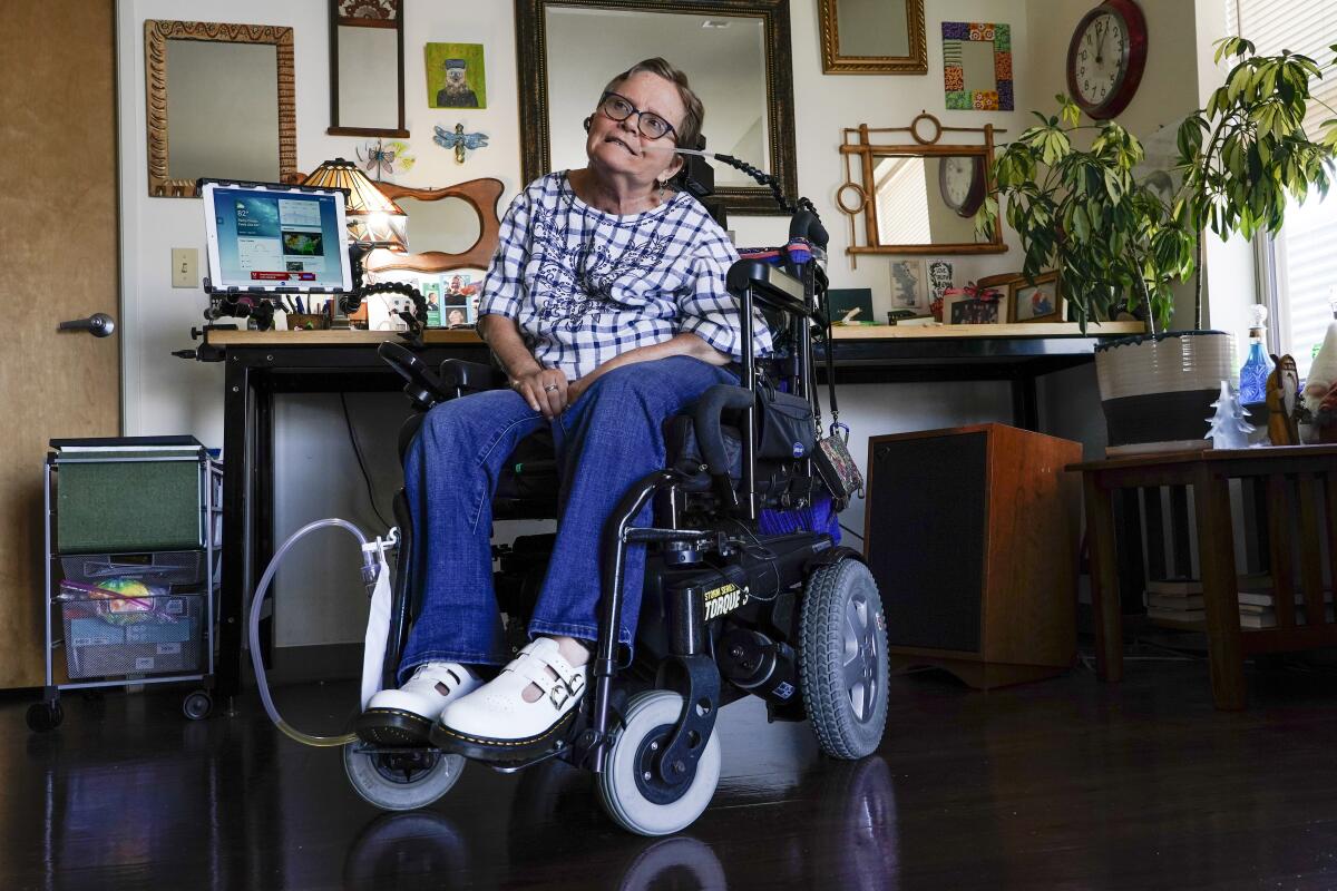 Martha Chambers sits in a wheelchair in her apartment.
