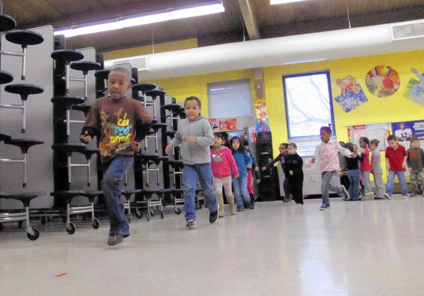Kindergarten students in Kansas City, Kan., run during a physical education class at Frank Rushton Elementary School, which has a high percentage of poor and at-risk children.