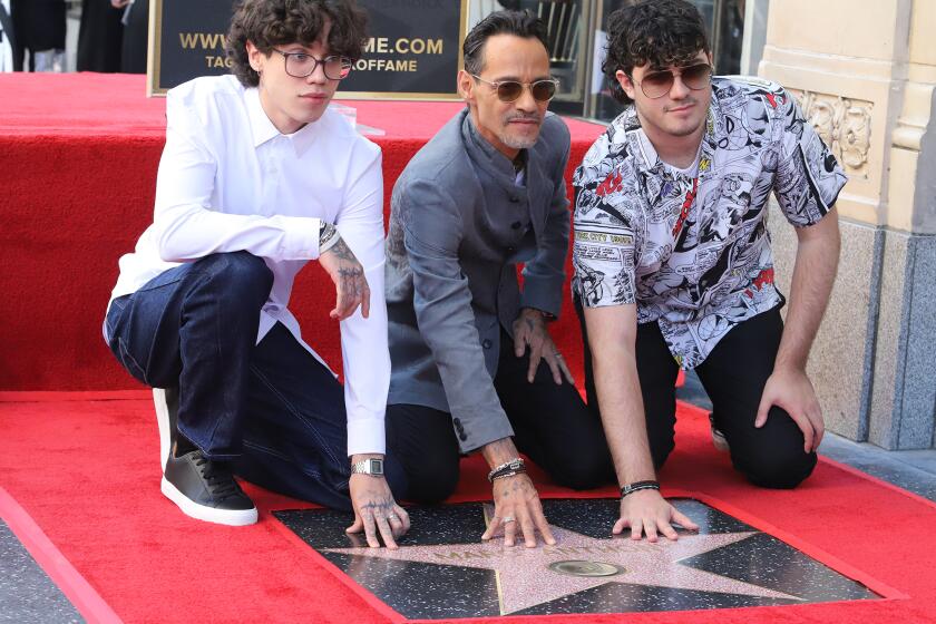 Marc Anthony is joined with his sons Ryan Adrian Muniz, left, and Christian Marcus Muniz as they pose for pictures as he receives a star on the Hollywood Walk of Fame in Hollywood on Thursday, September 7, 2023.