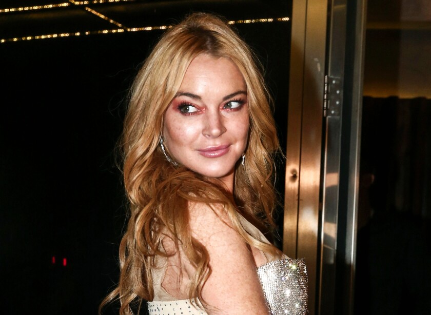 FILE - Actress Lindsay Lohan appears at the opening night of the Lohan Nightclub in Athens, Greece, Oct. 16, 2016. Lohan has told her followers on Instagram that she's engaged to boyfriend Bader Shammas. The 35-year-old ‘Mean Girls’ star has been based in the skyscraper-studded city of Dubai for several years. (AP Photo/Yorgos Karahalis, File)