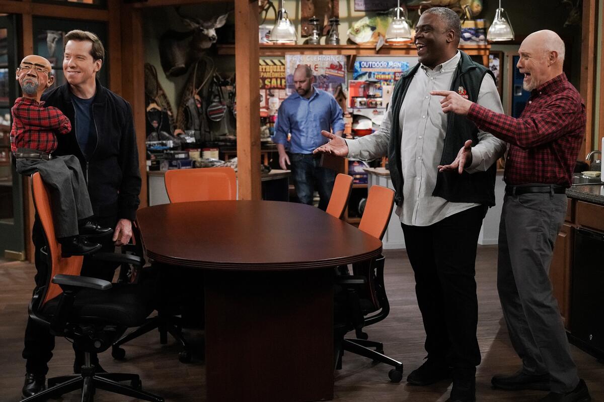 Jeff Dunham, Jonathan Adams and Hector Elizondo stand around a table in "Last Man Standing."