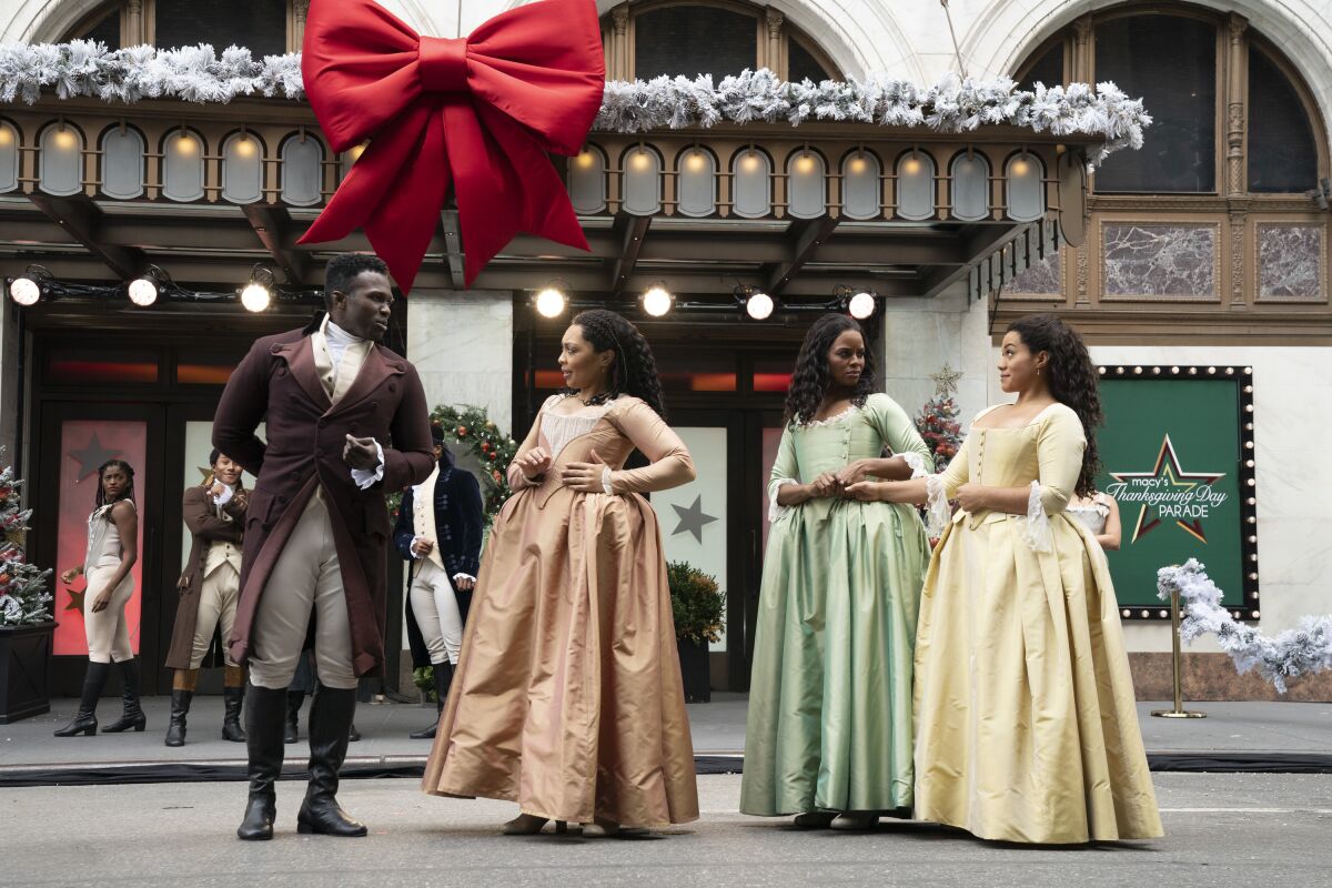 Joshua Henry performs with the cast of "Hamilton" in the parade.