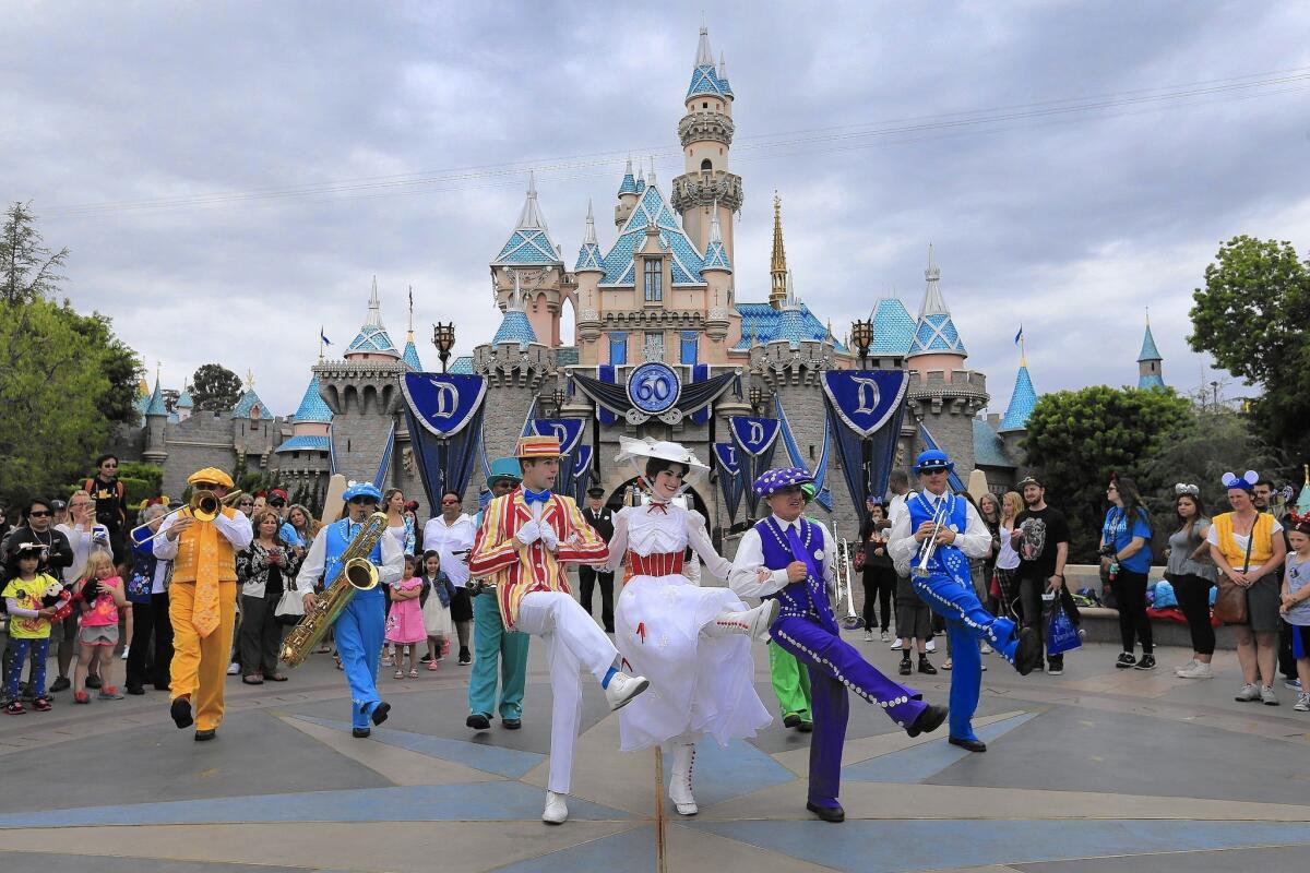 Disney characters sing and dance in front of Sleeping Beauty Castle in May during the kickoff of Disneyland’s 60th anniversary celebration.