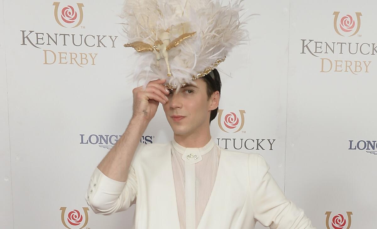 Figure skater Johnny Weir, shown at the 104th Kentucky Derby, announced Tuesday that he and husband Victor Voronov are back together. And, yes, that's Pegasus on the hat.
