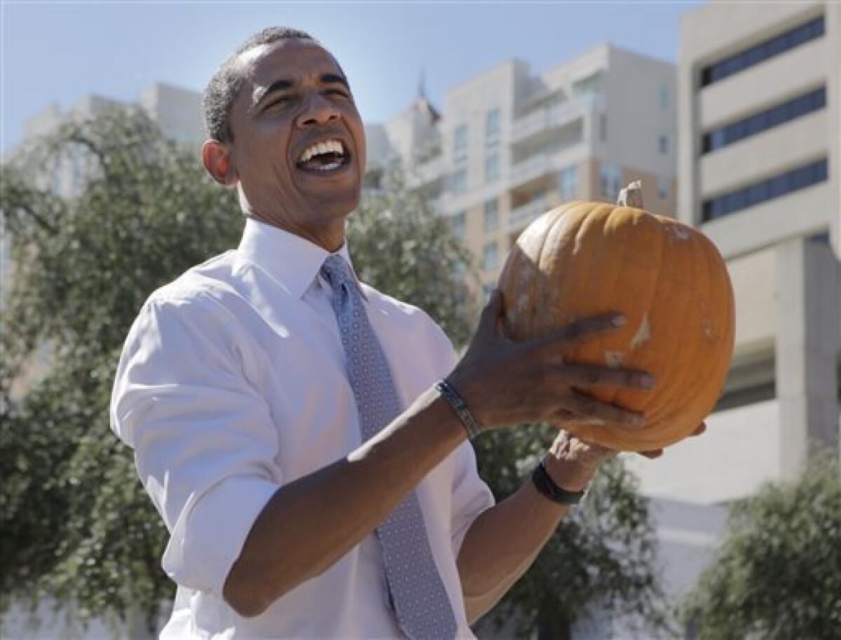 Democratic presidential candidate Sen. Barack Obama, D-Ill. holds a pumpkin at the First United Methodist Church Pumpkin Patch in Sarasota, Fla., Thursday, Oct. 30, 2008. (AP Photo/Jae C. Hong)