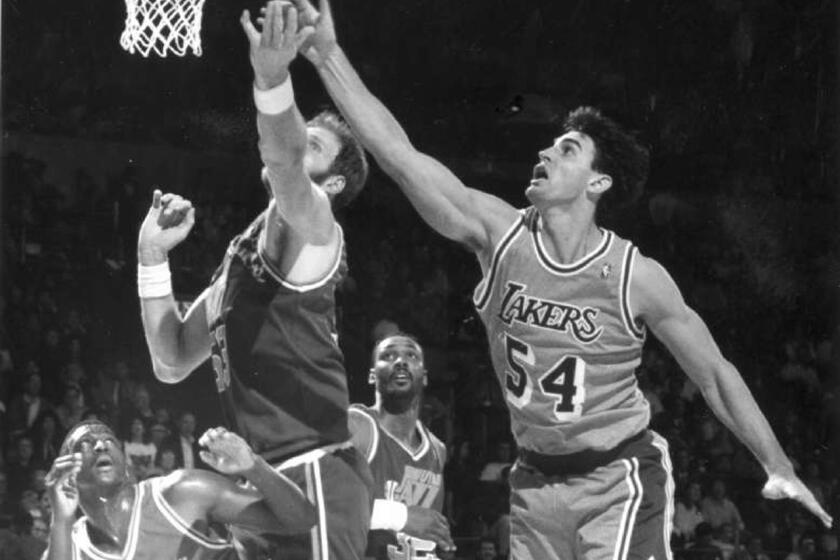 Former Laker Jack Haley and Utah's Mark Eaton, left, battle for a rebound during a game in December of 1991. Haley died Monday. He was 51.