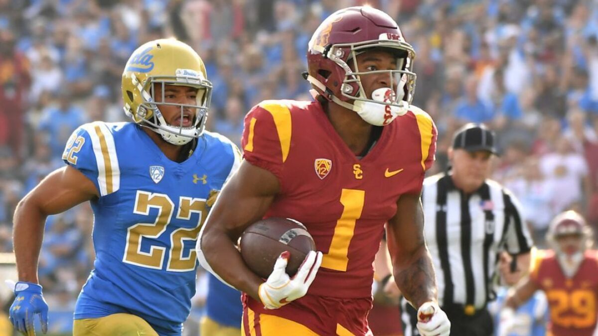 USC receiver Velus Jones Jr. sprints to the end zone in front of UCLA defensive back Nate Meadors on Oct. 17 at the Rose Bowl.