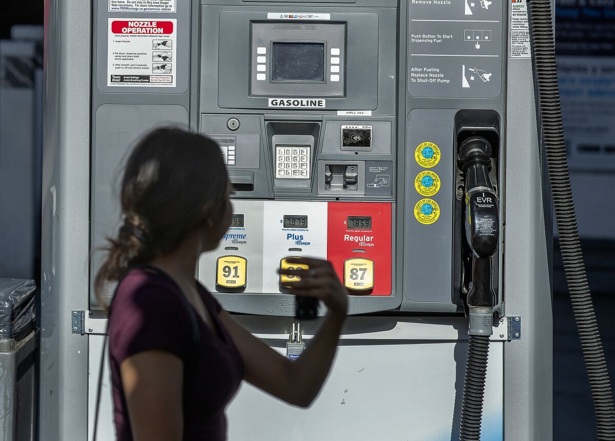 A screen at a gas pump shows gasoline selling for nearly $8 per gallon in L.A.