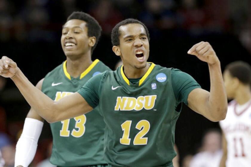 Lawrence Alexander of 12th-seeded North Dakota State celebrates during the Bison's upset of fifth-seeded Oklahoma, 80-75, in overtime of the second round of the NCAA tournament.