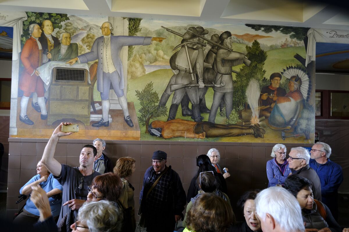 People fill the main entryway of George Washington High School in San Francisco to view the 13-panel, 1,600-square-foot mural titled "Life of Washington" during an open house in August for the public.