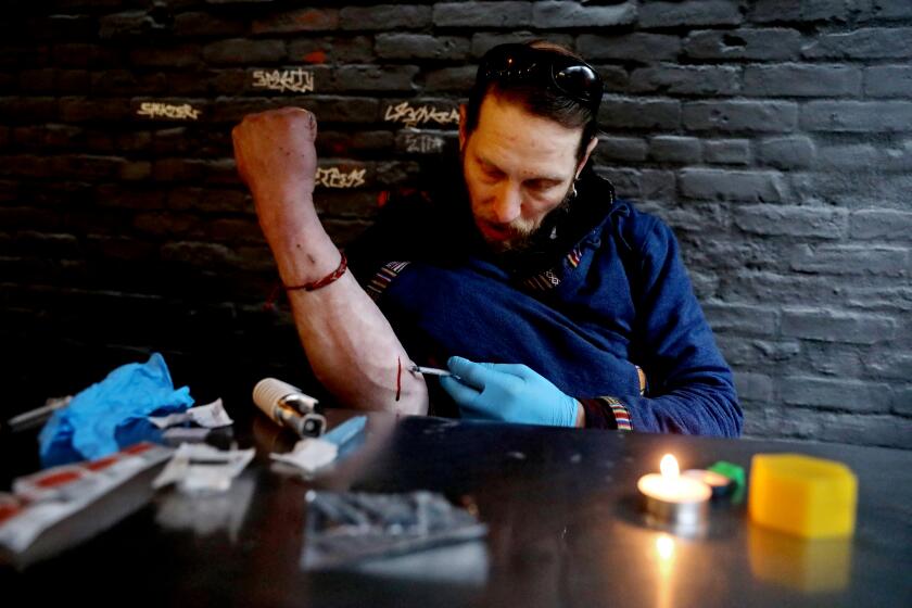 VANCOUVER, BRITISH COLUMBIA - MAY 03: Geoffrey Bordas, 37, of Ontario, a fentanyl addict who also works at the Overdose Prevention Society (OPS), gives himself an injection of fentanyl at OPS in the Downtown Eastside (DTES) neighborhood on Tuesday, May 3, 2022 in Vancouver, British Columbia. OPS is a supervised consumption site in the DTES giving addicts who use fentanyl, opioids, crystal methamphetamine and other drugs a place to use and get harm reduction supplies; clean syringes, alcohol swabs, sterile water, tourniquets, spoons and filters. On April 14, 2016, provincial health officer Dr. Perry Kendall declared a public health emergency under the Public Health Act due to the significant rise in opioid-related overdose deaths reported in B.C. since the beginning of 2016. (Gary Coronado / Los Angeles Times)