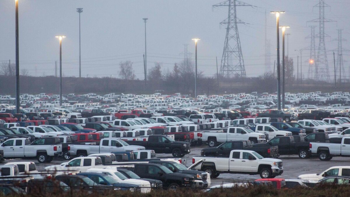 General Motors vehicles are parked outside the GM assembly plant in Oshawa, Canada.