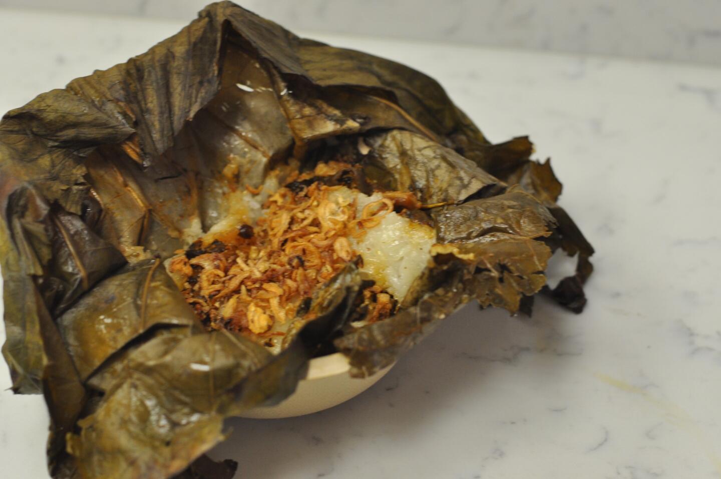 Mushroom Lo Mai Gai, sticky rice with mushrooms, black beans and shallots cooked in a lotus leaf.